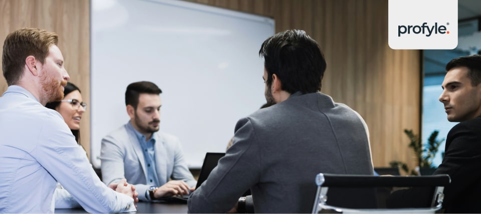 A sales meeting with salespeople discussing lead scoring